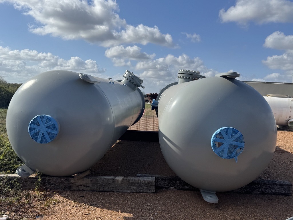 End view of two grey separator vessels with bolted heads